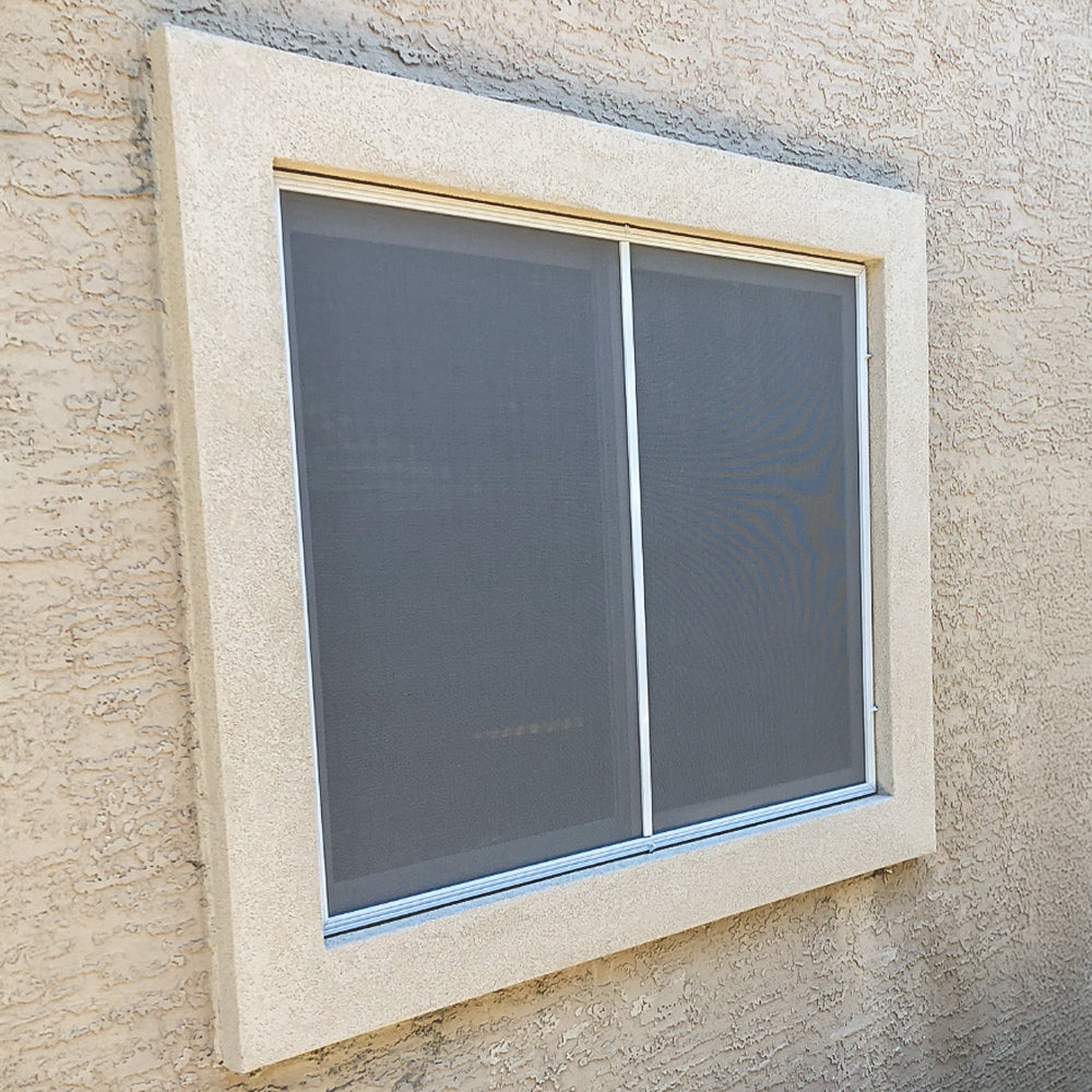 custom dusk grey solar screen installed on residential window with white frame.