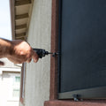 Technician installing custom solar screen on window frame in Rocklin California